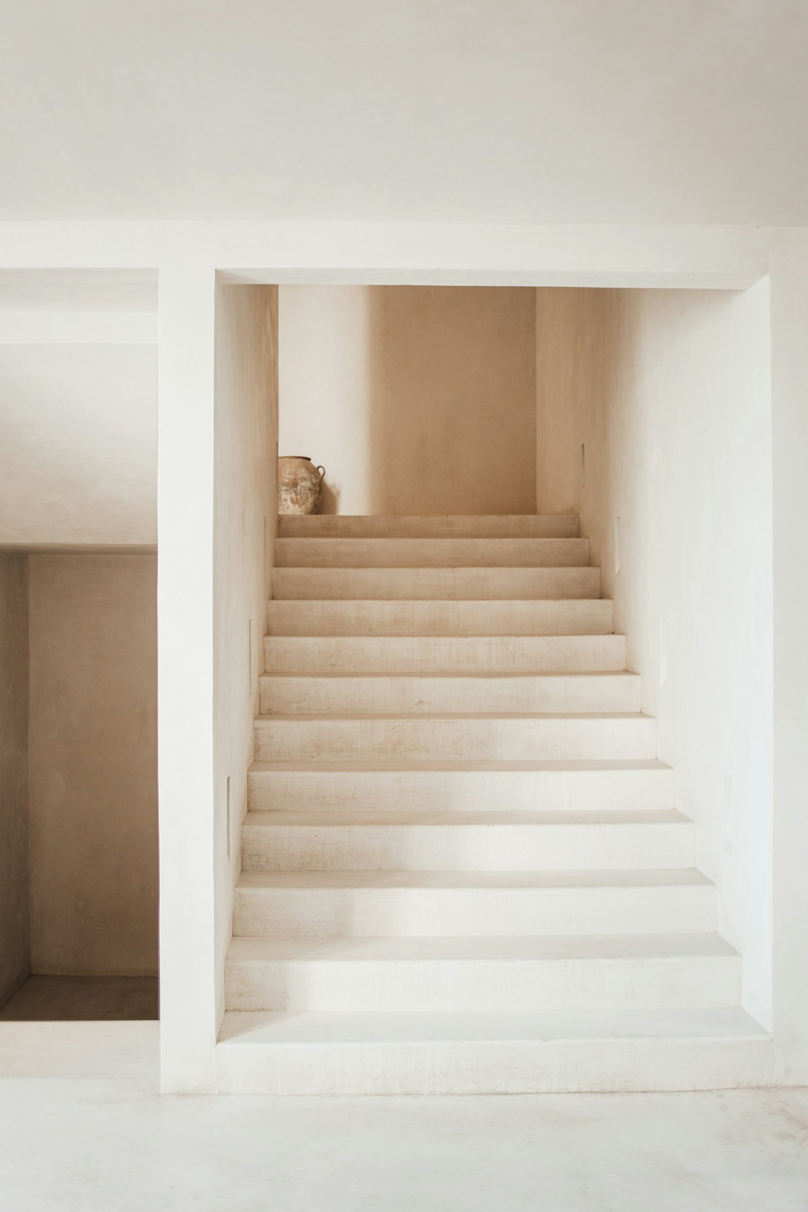 A quiet, minimal staircase bathed in soft natural light