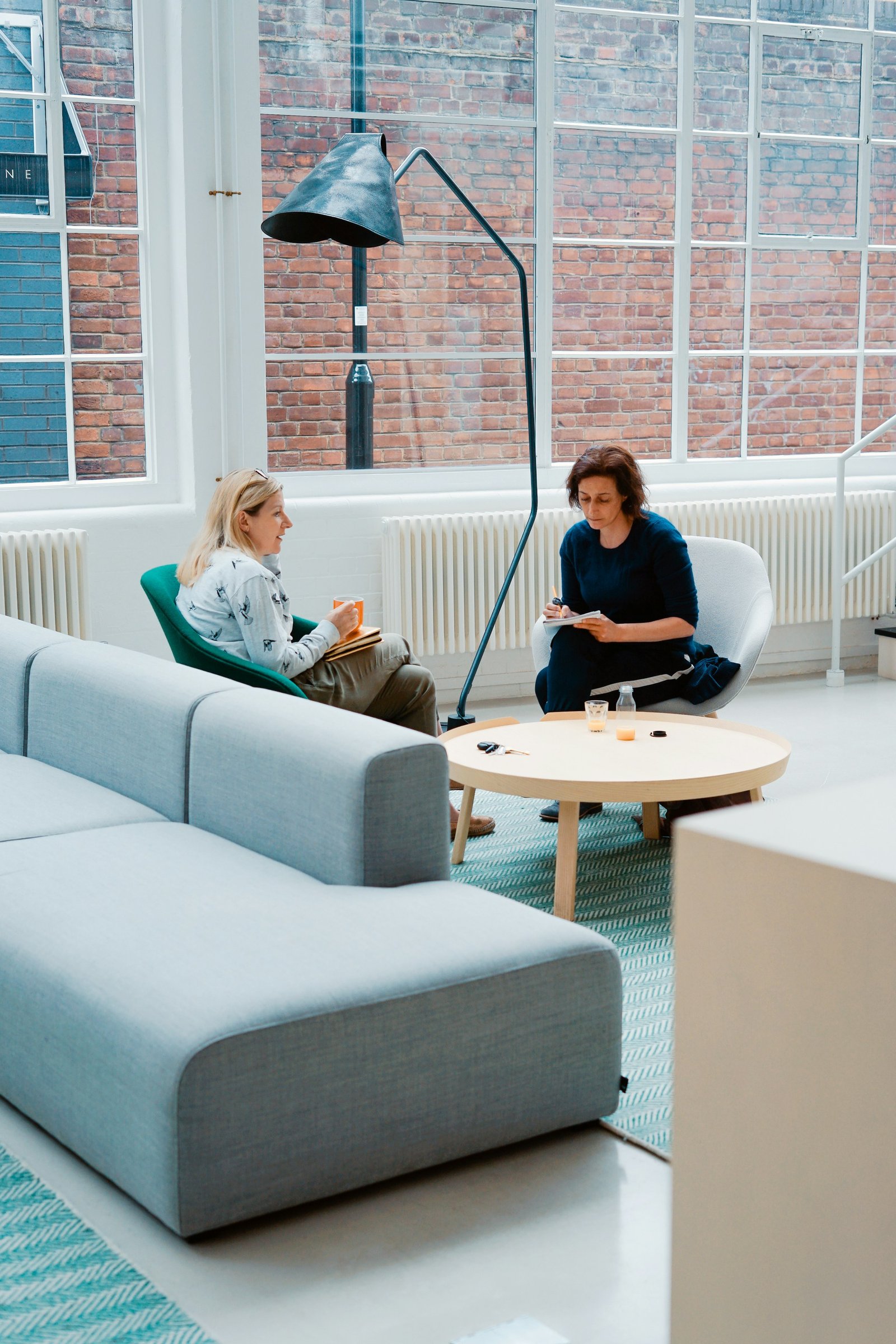 Two professionals in a genuine coaching conversation