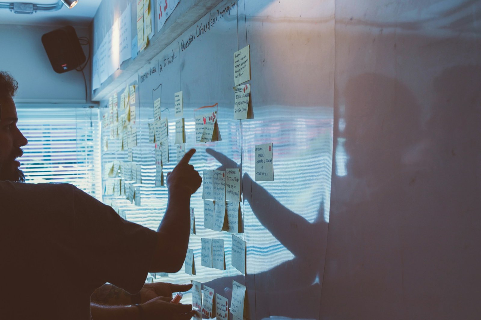 A consultant mapping out strategy on a glass board