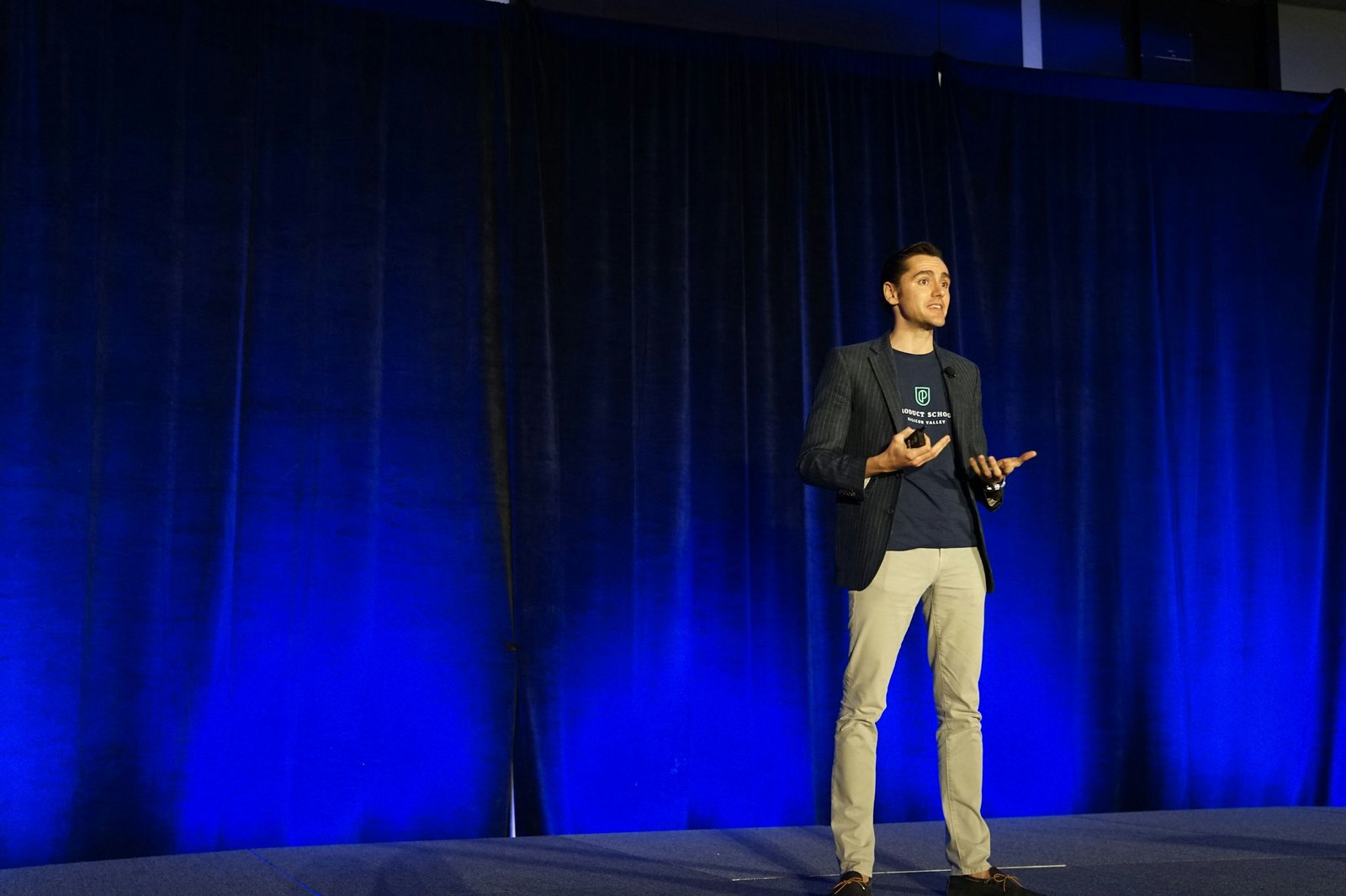 A speaker addressing an audience on stage