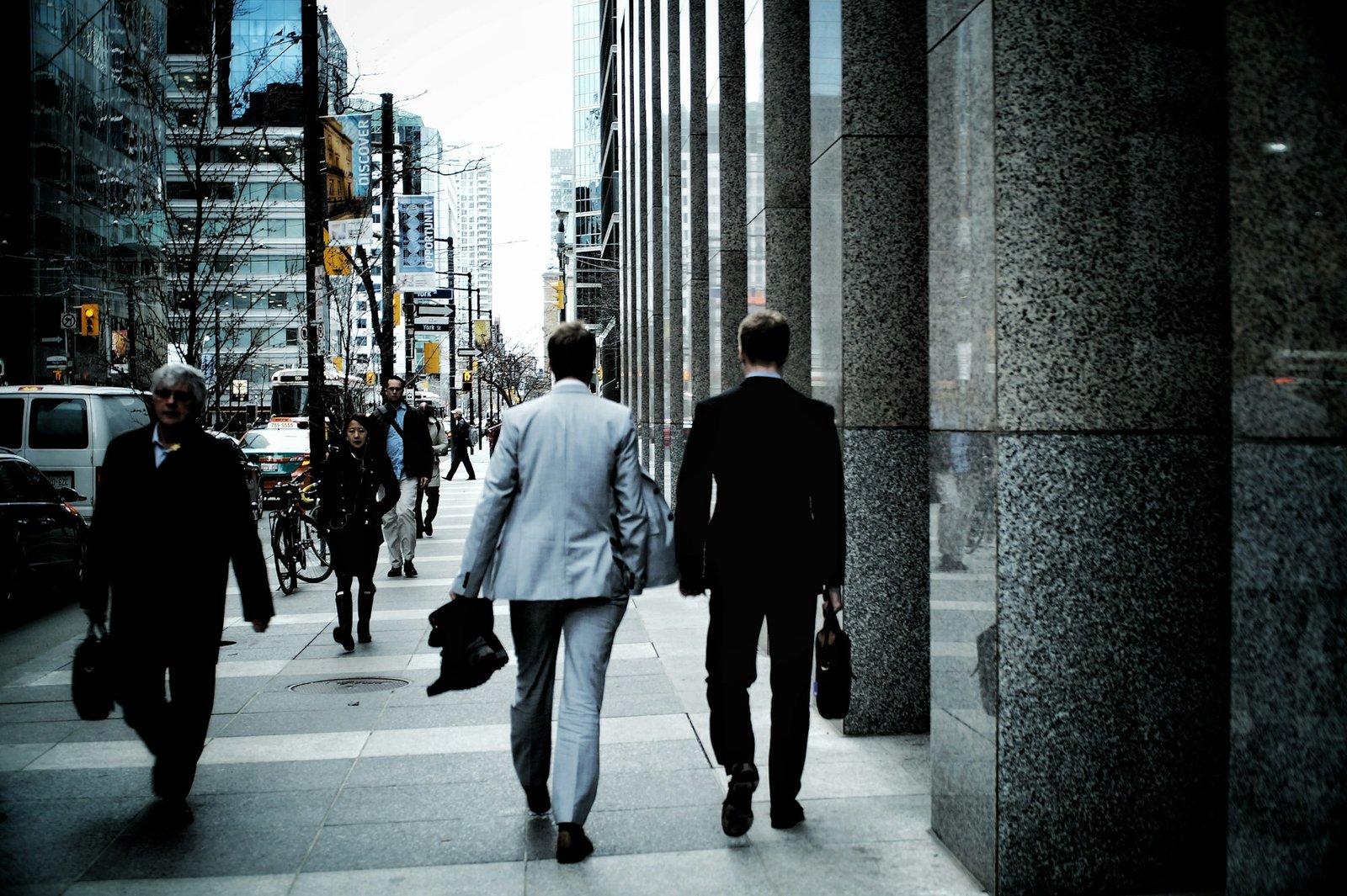 Two professionals walking together through the city, deep in conversation